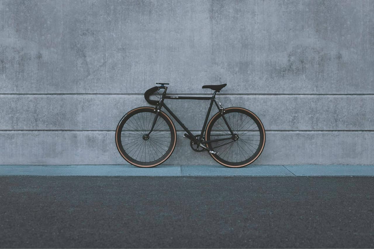 Black city bicycle against a concrete wall. Not a listed e-bike model.